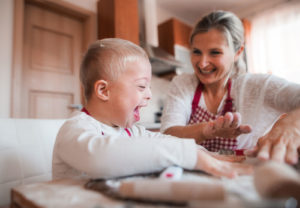 Special needs child playing with his mother