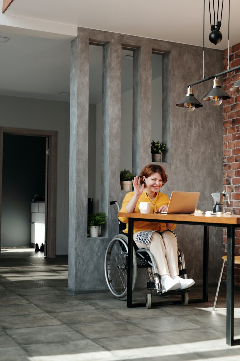 Woman at work in wheelchair at trendy coffee house